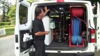 man explaining his carpet cleaning equipment