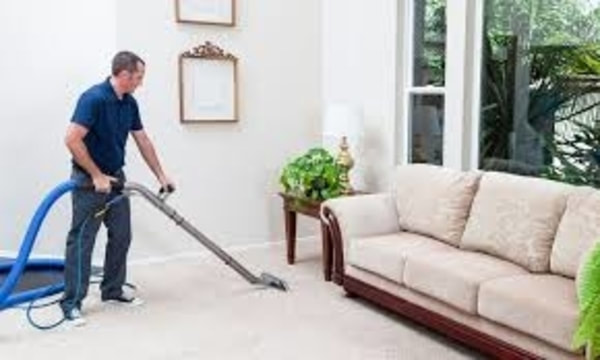 Man steam cleaning carpet